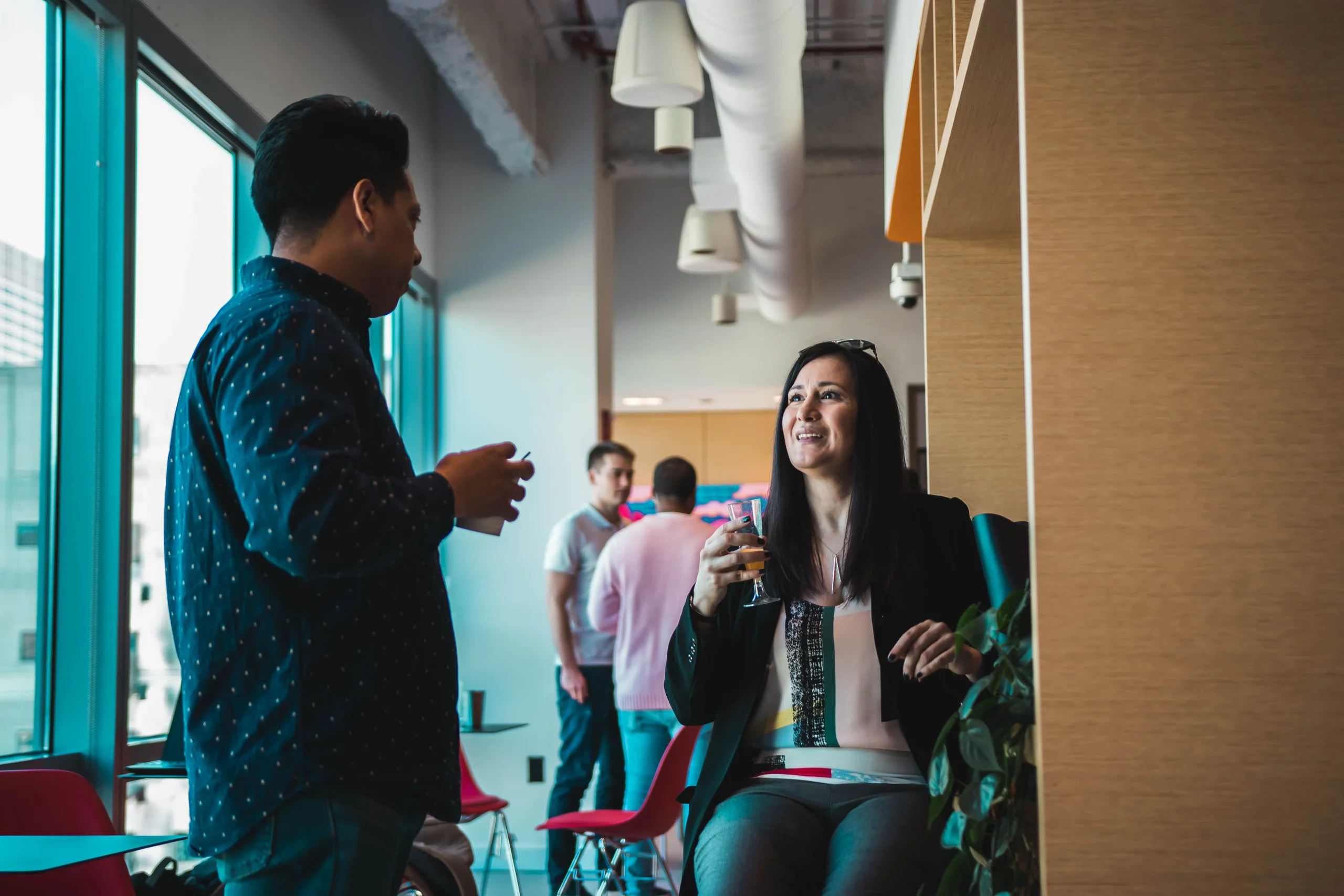 People connecting in conversation at a re:WORK community gathering